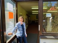 Frau Herrmann öffnet die Tür zur Gemeindebibliothek Seebach